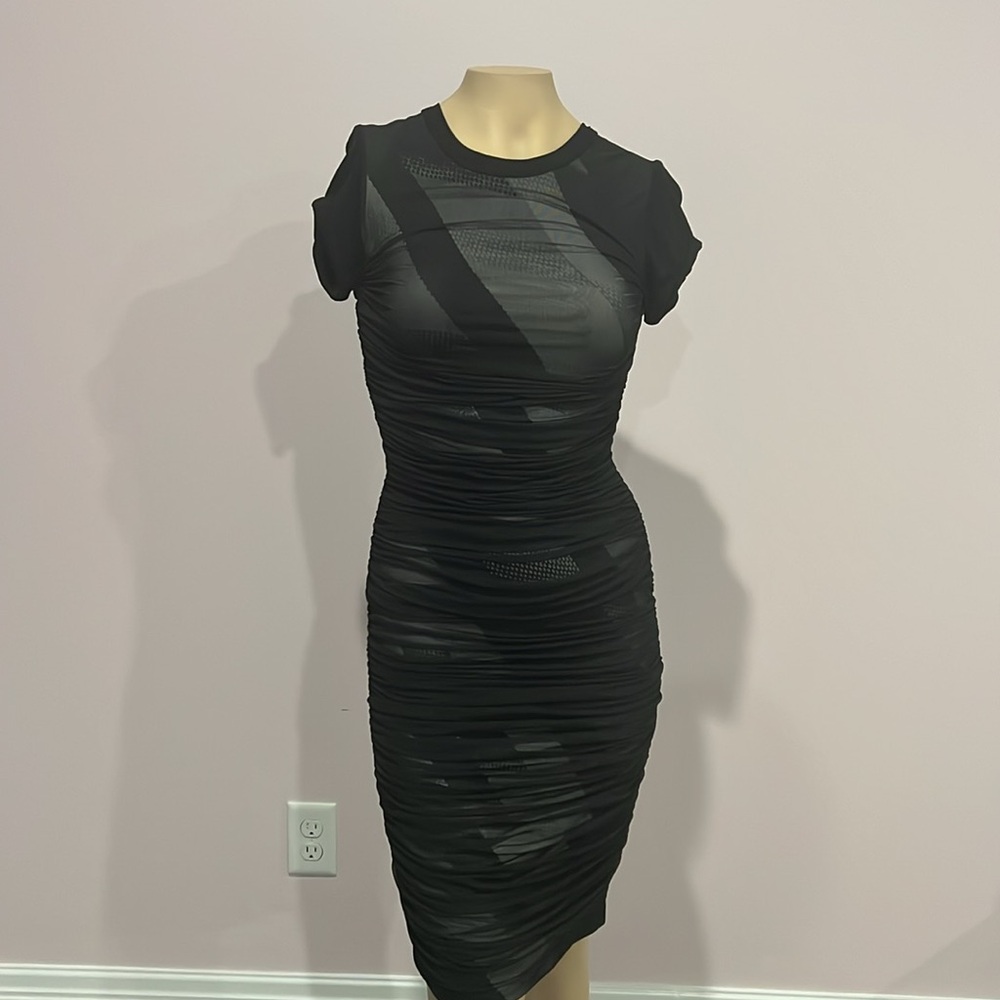 Never worn BCBG mesh overlay black dress asymmetrical designs underneath size XS